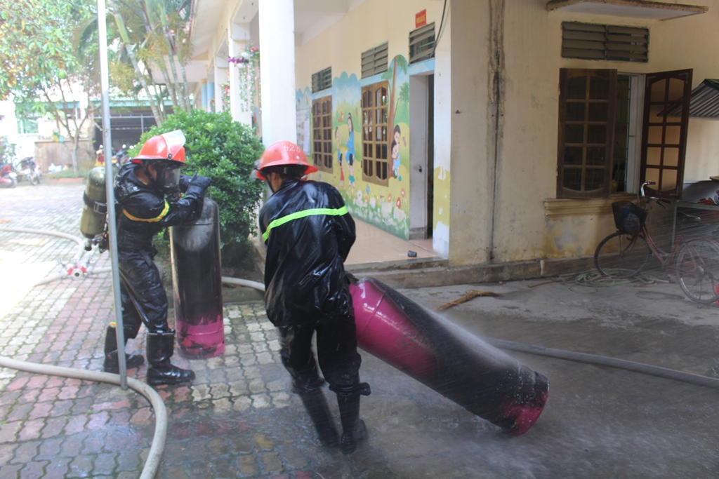 Lực lượng chữa cháy di chuyển bình gas ra khu vực an toàn cách xa khu dân cư