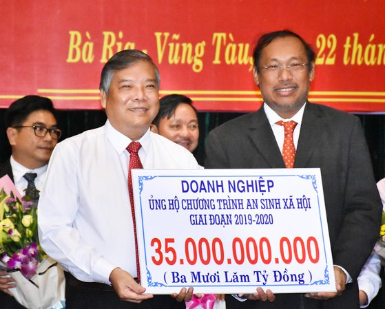 Đại diện Tập đoàn SCG Thái Lan trao tấm séc tượng trưng 35 tỷ đồng cho đại diện UBMTTQVN tỉnh.