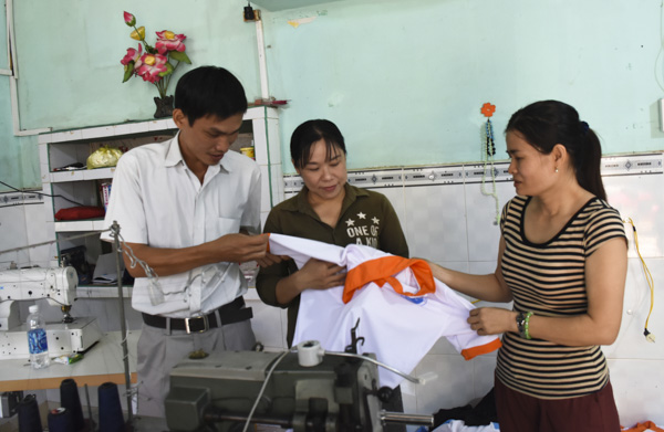 Bà Trương Thị Ngọc Thọ (bìa phải, ở xã Kim Long, huyện Châu Đức) trao đổi về nghề may gia công với cán bộ  Phòng LĐTBXH huyện Châu Đức.
