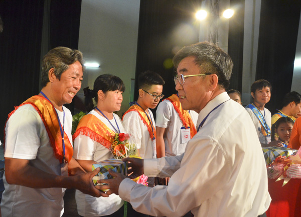 Ông Phạm Hoàng Long, phụ trách phòng Nếp sống văn hóa và gia đình (Sở VH-TT), Phó Ban Tổ chức Ngày hội Gia đình tặng quà chúc mừng các gia đình tham gia hội thi.