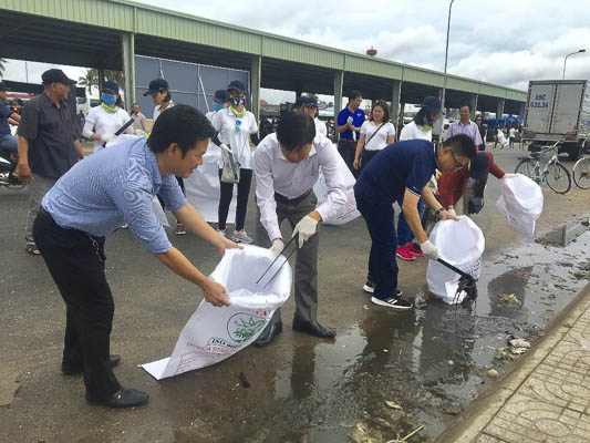 Ông Trần Văn Tuấn (giữa), Phó Chủ tịch UBND tỉnh tham gia thu gom rác cùng các tình nguyện viên.