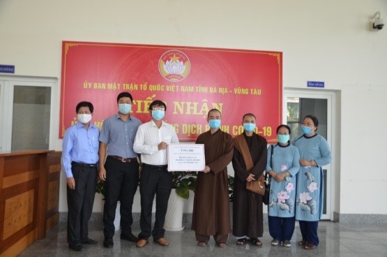 Thầy Thích Khải Tạng, đại diện chùa Phật Quang (thứ tư từ phải qua) tặng 300 suất quà thông qua UBMTTQVN tỉnh.