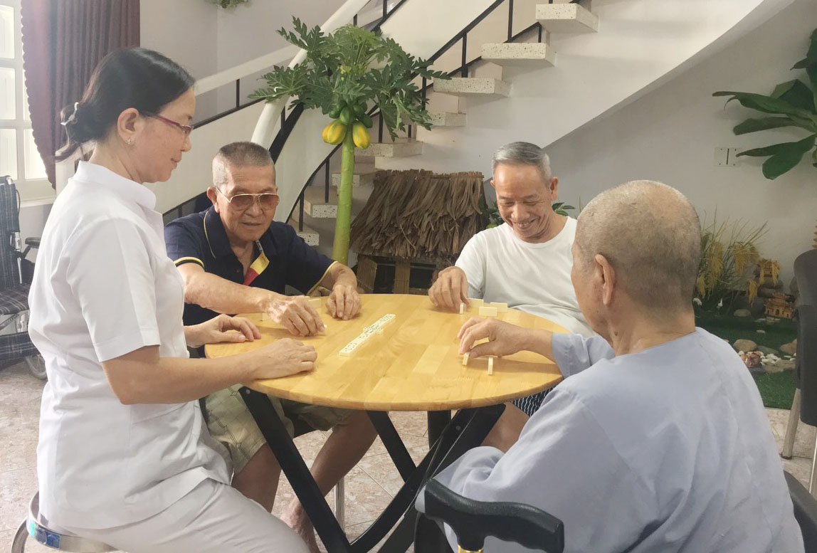 Điều dưỡng Trần Thị Dừng chơi cờ Domino cùng các cụ Trần Minh, Nguyễn Chí Hòa và Đoàn Thị Nhâm.