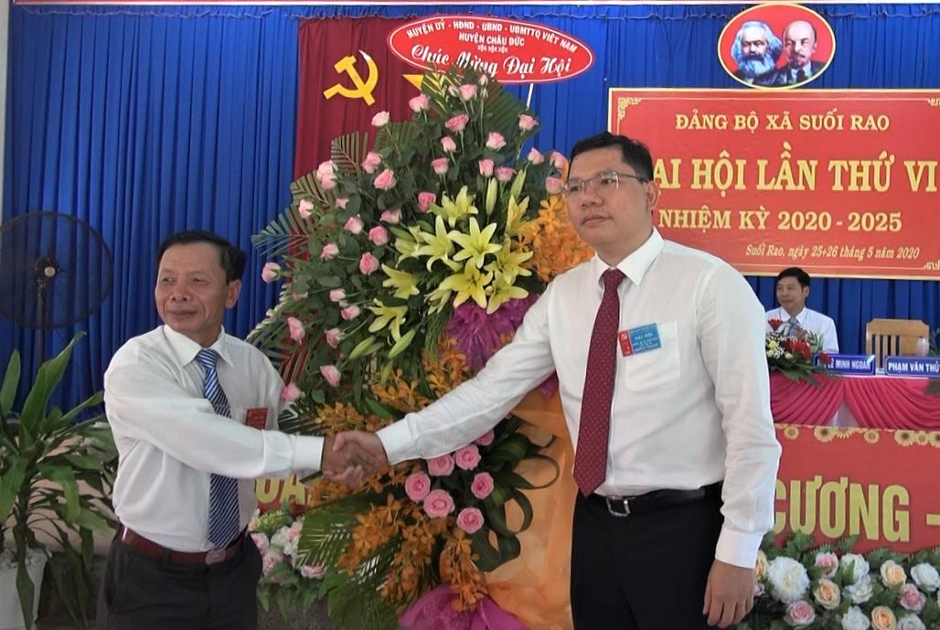 Đồng chí Nguyễn Quốc Toản (bên trái), Bí thư Đảng ủy xã Suối Rao nhận lẳng hoa chúc mừng Đại hội do đồng chí Hoàng Nguyên Dinh, Chủ tịch UBND huyện Châu Đức trao tặng.
