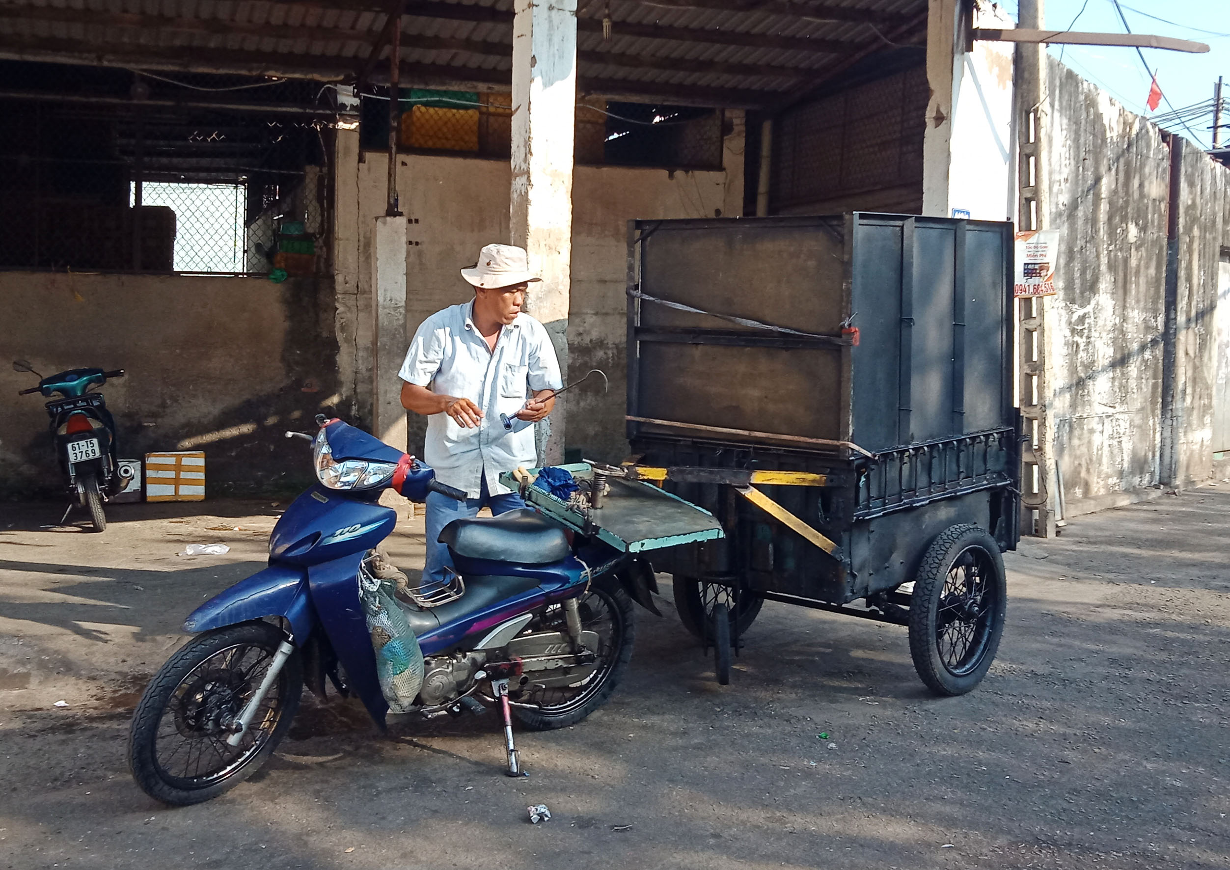 Một xe máy kéo theo thùng xe tự chế bán rau củ tại đường Trần Phú, TP. Vũng Tàu. (Ảnh chụp chiều 20/3).