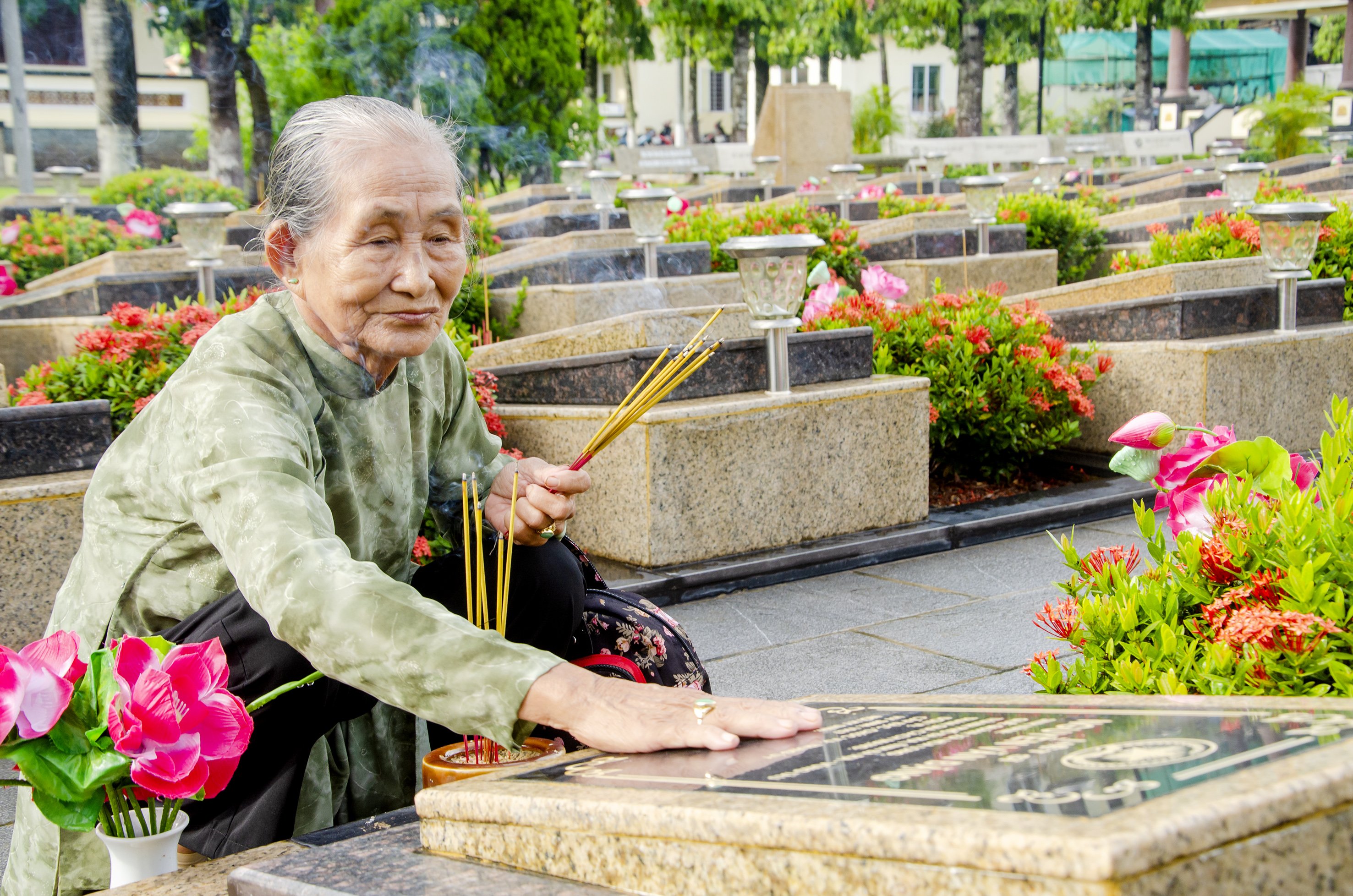 Bà Lê Thị Trí xúc động bên phần mộ của chồng - Liệt sĩ Nguyễn Văn Đặng (quê quán xã Hòa Long, TP. Bà Rịa hy sinh năm 1967). Ảnh: MẠNH THẮNG