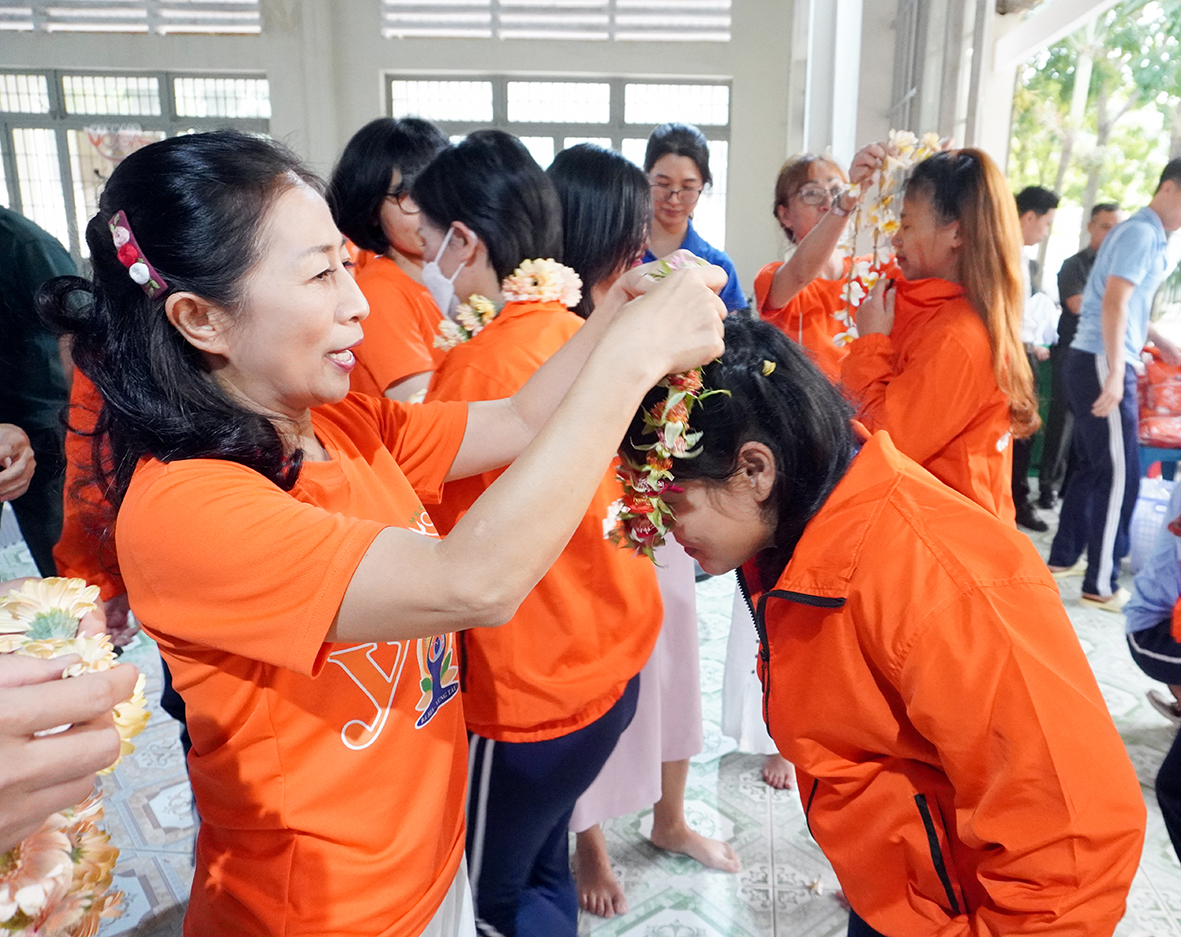 ThS Phan Mai Hương, Giám đốc Trung tâm Yoga Mermaid đeo vòng hoa cho các học viên của Trung tâm cai nghiện tỉnh.