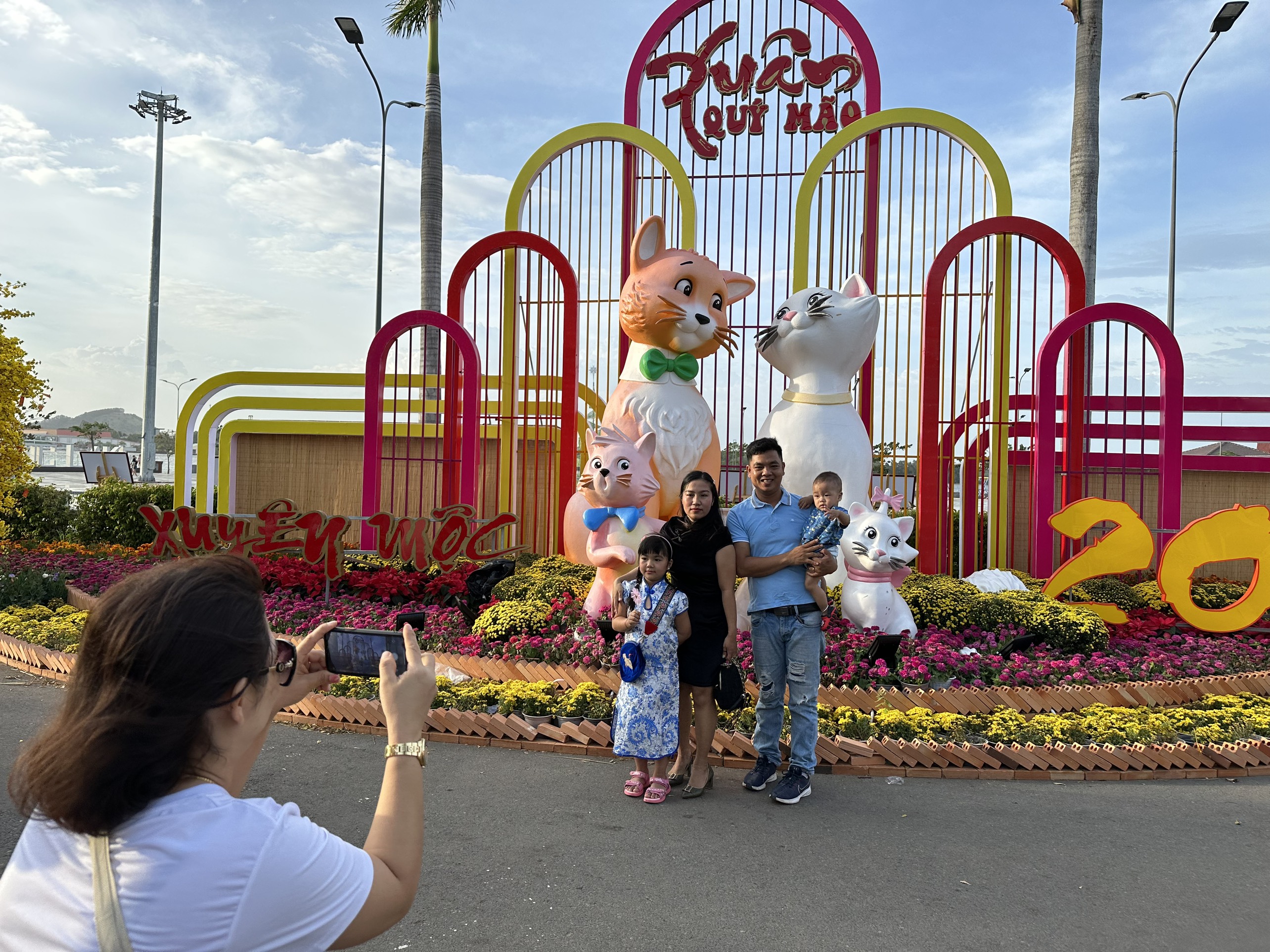 Một gia đình đến tham quan, chụp hình kỷ niệm tại đường hoa Xuyên Mộc trong buổi chiều Mùng 3 Tết.