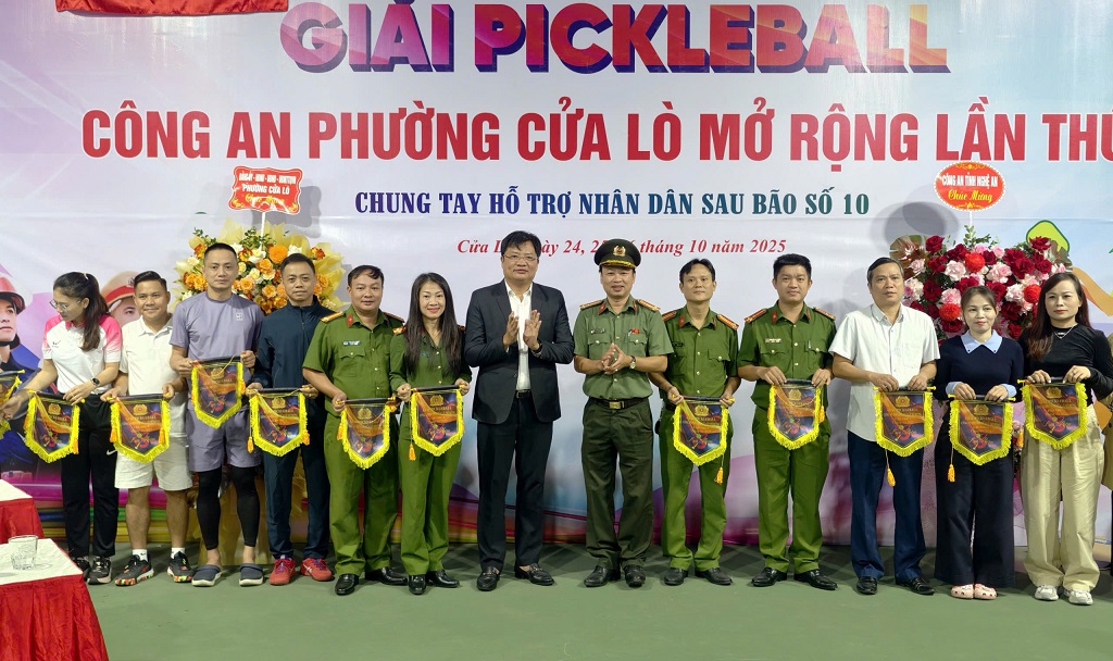 Đồng chí Ngô Đức Kiên - Bí thư Đảng ủy, Chủ tịch HĐND phường Cửa Lò và đại diện Lãnh đạo Phòng Công tác chính trị Công an tỉnh tặng cờ lưu niệm cho các đội tham gia thi đấu 