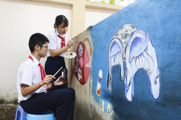 HS lớp 7/1, Trường THCS Nguyễn An Ninh tô màu tranh tường với chủ đề bảo vệ môi trường.