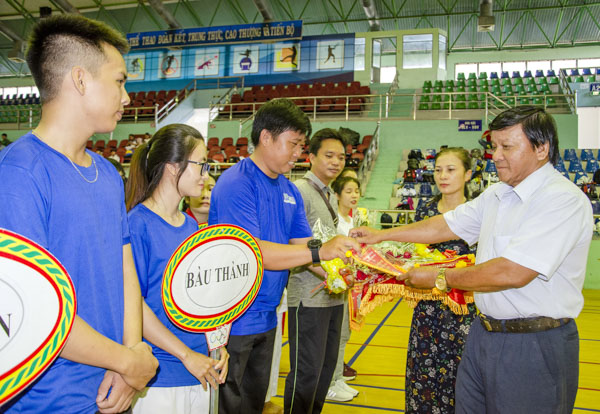 Ông Đặng Văn Cường, Giám đốc Trung tâm Huấn luyện và thi đấu TDTT tỉnh trao cờ lưu niệm và tặng hoa chúc mừng cho các đội VĐV.