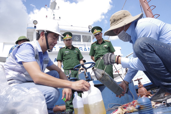 Lực lượng BĐBP tỉnh phối hợp với cơ quan giám định Vinacontrol - Chi nhánh Phú Mỹ lấy mẫu giám định phẩm chất hàng hóa và giám định khối lượng dầu DO trên phương tiện BV 97979 TS.