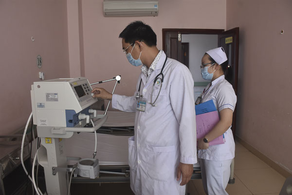 Bác sĩ Nguyễn Văn Phi kiểm tra thiết bị điều trị cho bệnh nhân tại khu vực bố trí tiếp nhận điều trị cách ly  bệnh nhân nhiễm COVID-19.
