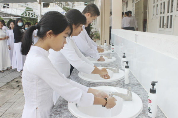 Khi học sinh đi học trở lại, nhà trường vẫn phải tiếp tục thực hiện nghiêm các khuyến cáo của Bộ Y tế về phòng chống COVID-19. Ảnh KHÁNH CHI