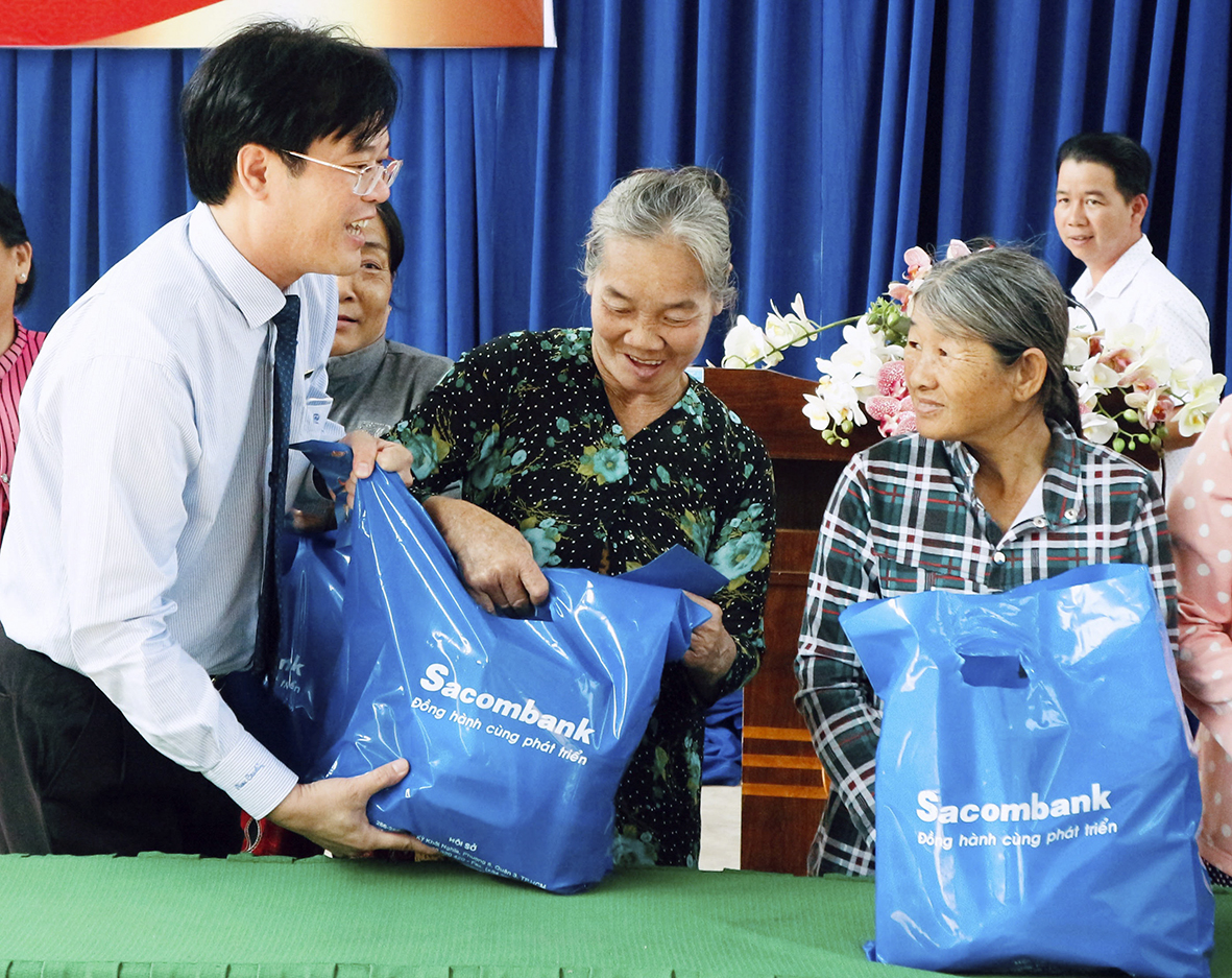 Ông Trần Quốc Khang, Giám đốc Ngân hàng Sacombank Chi nhánh Bà Rịa tặng quà cho các hộ nghèo, hộ có hoàn cảnh khó khăn trên địa bàn xã Phước Hội.