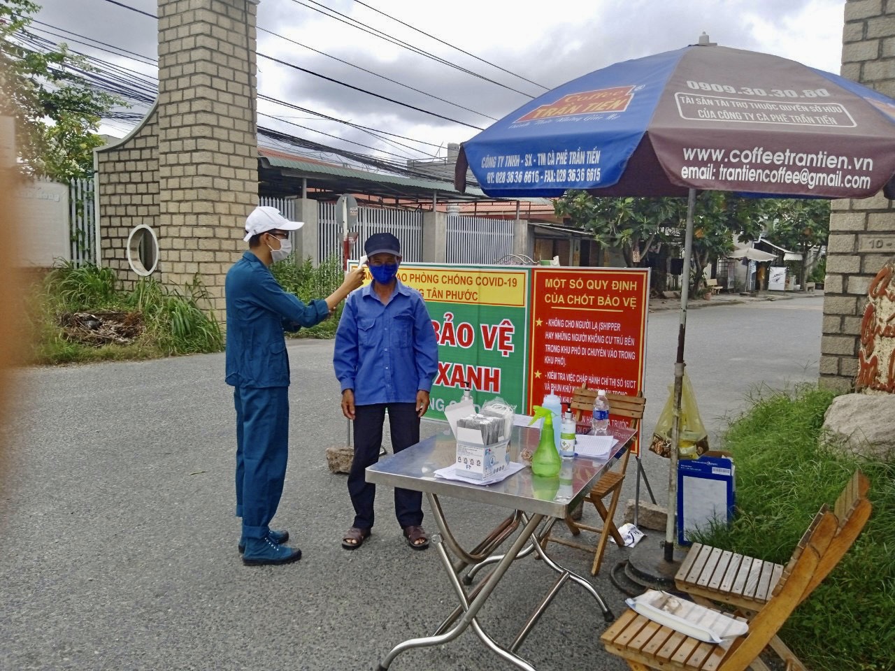 Lực lượng chức năng kiểm tra thân nhiệt của người dân trước khi vào “vùng xanh” phường Tân Phước (TX. Phú Mỹ). Ảnh: MINH TÂM