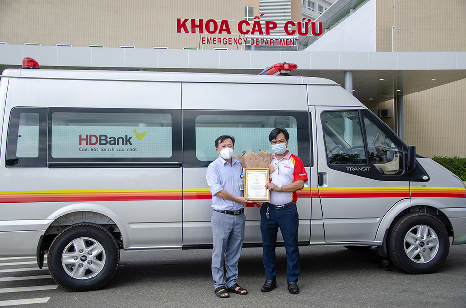 Đại diện Cơ sở điều trị bệnh nhân COVID-19 Bệnh viện Vũng Tàu (trái) tiếp nhận xe cứu thương do HDBanhk trao tặng.