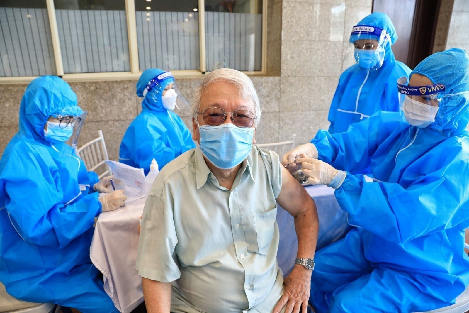 Nhân viên ty tế ế tiêm vaccine phòng COVID-19 cho người cao tuổi trên địa bàn quận Hoàn Kiếm. Ảnh: TTXVN
