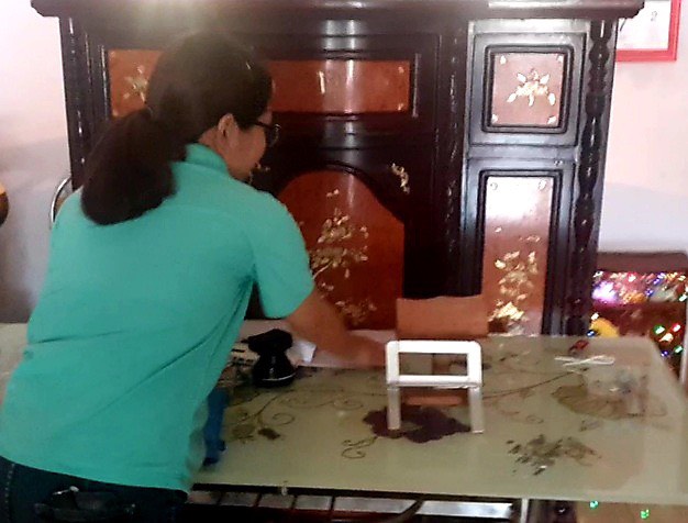 Chị Lê Thị Thu Lành bên chiếc bàn học của con trai lớp 1, nơi đối tượng vào giật điện thoại.