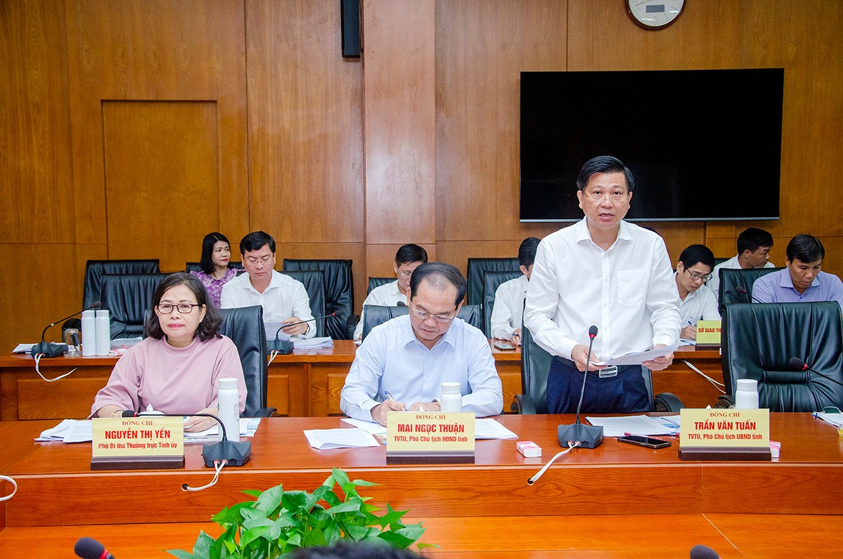 Phó Chủ tịch UBND tỉnh Trần Văn Tuấn trình bày báo cáo về tình hình phát triển công nghiệp hoá - hiện đại hoá trên địa bàn tỉnh trong 20 năm qua.