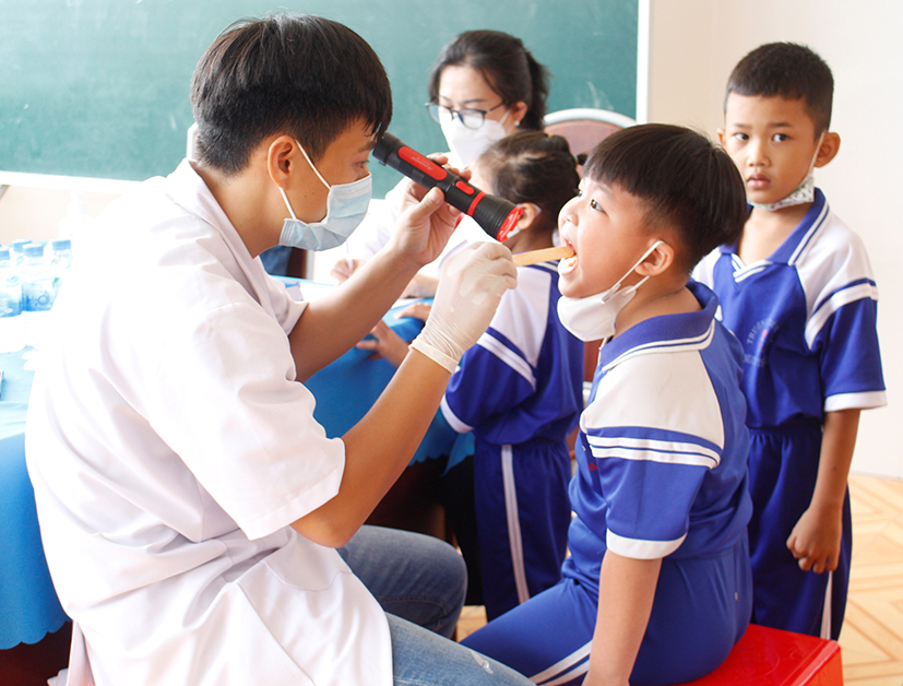 Bác sĩ của TTYT Đất Đỏ khám sức khỏe cho HS Trường TH Nguyễn Thị Hoa.