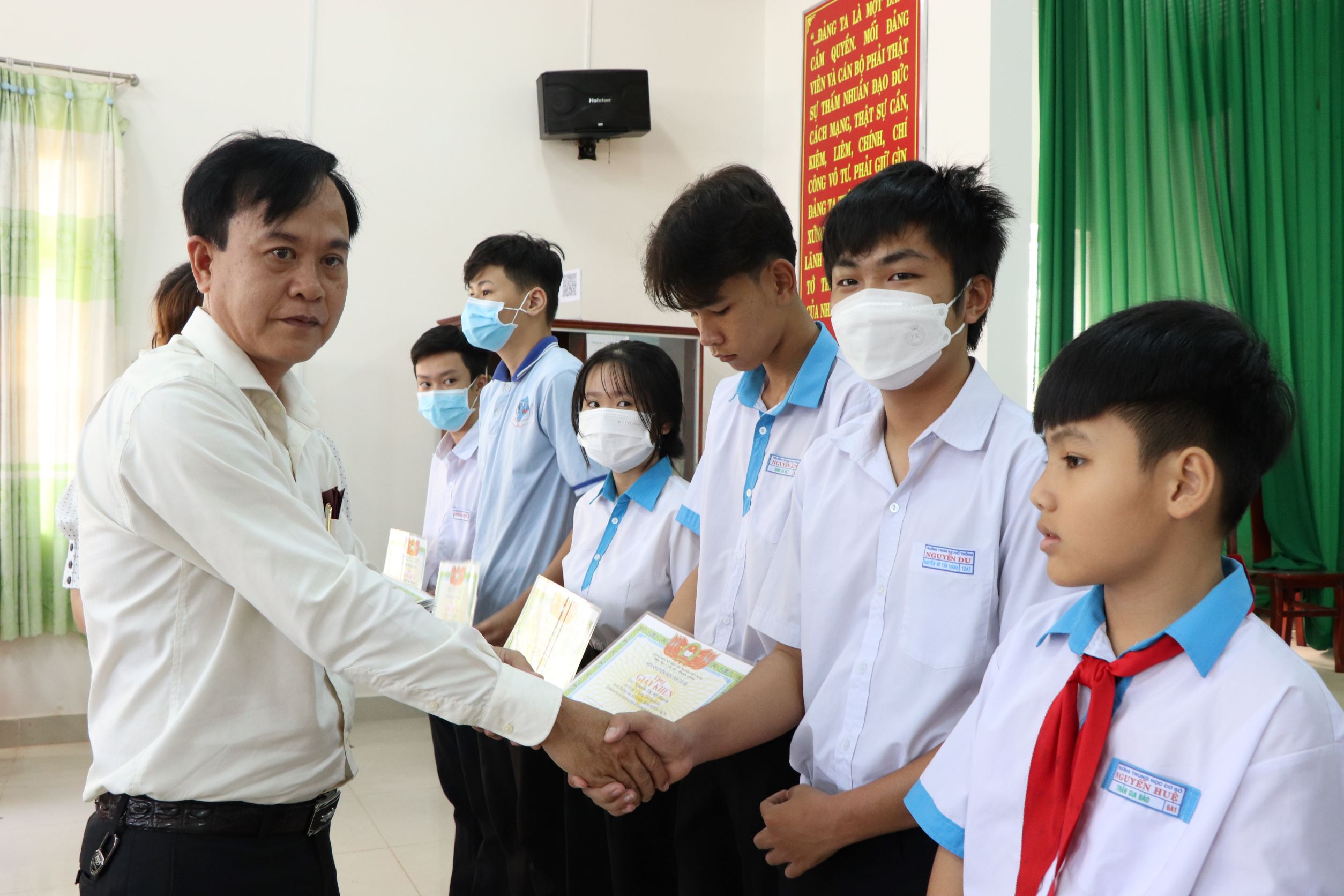 Ông Hoàng Tỷ, Chủ tịch UBND xã Cù Bị trao học bổng cho HS nghèo hiếu học.