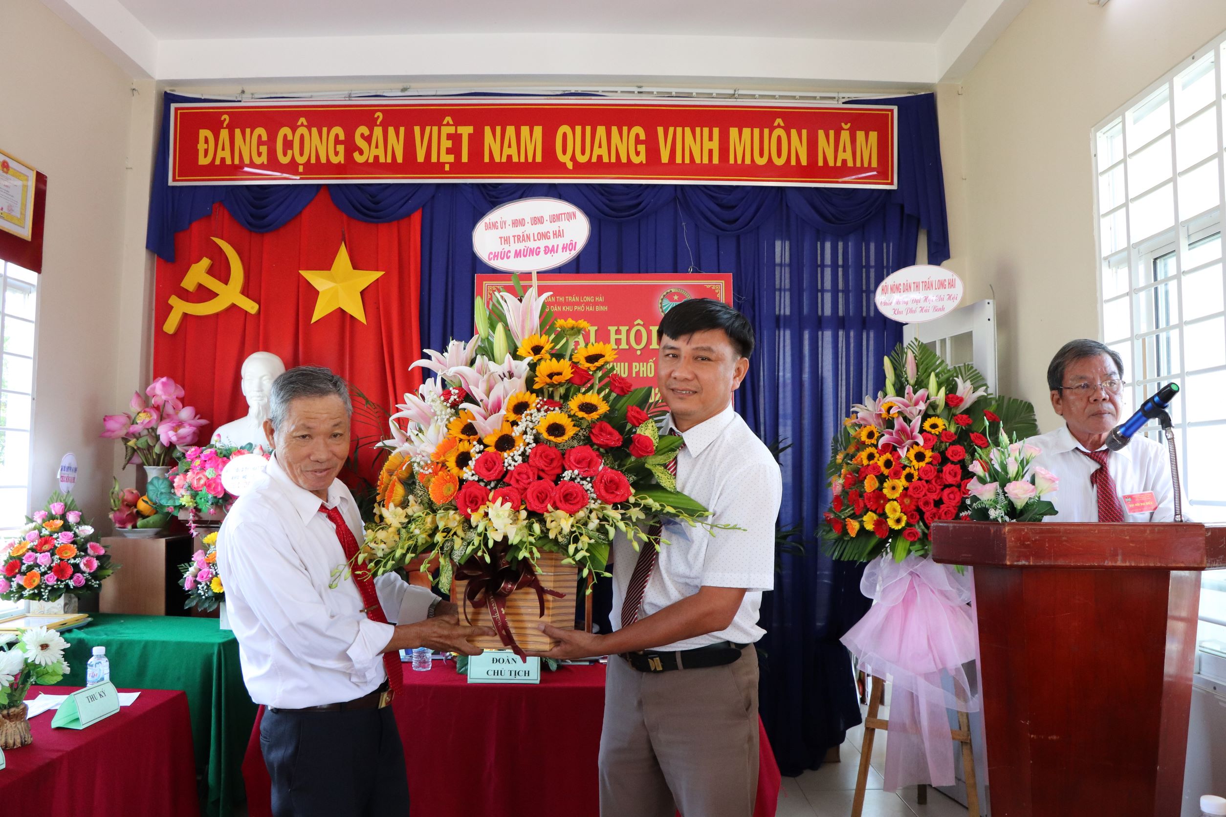 Ông Trần Thanh Minh (bên phải), Phó Bí thư Thường trực Đảng ủy TT. Long Hải tặng hoa chúc mừng Đại hội.