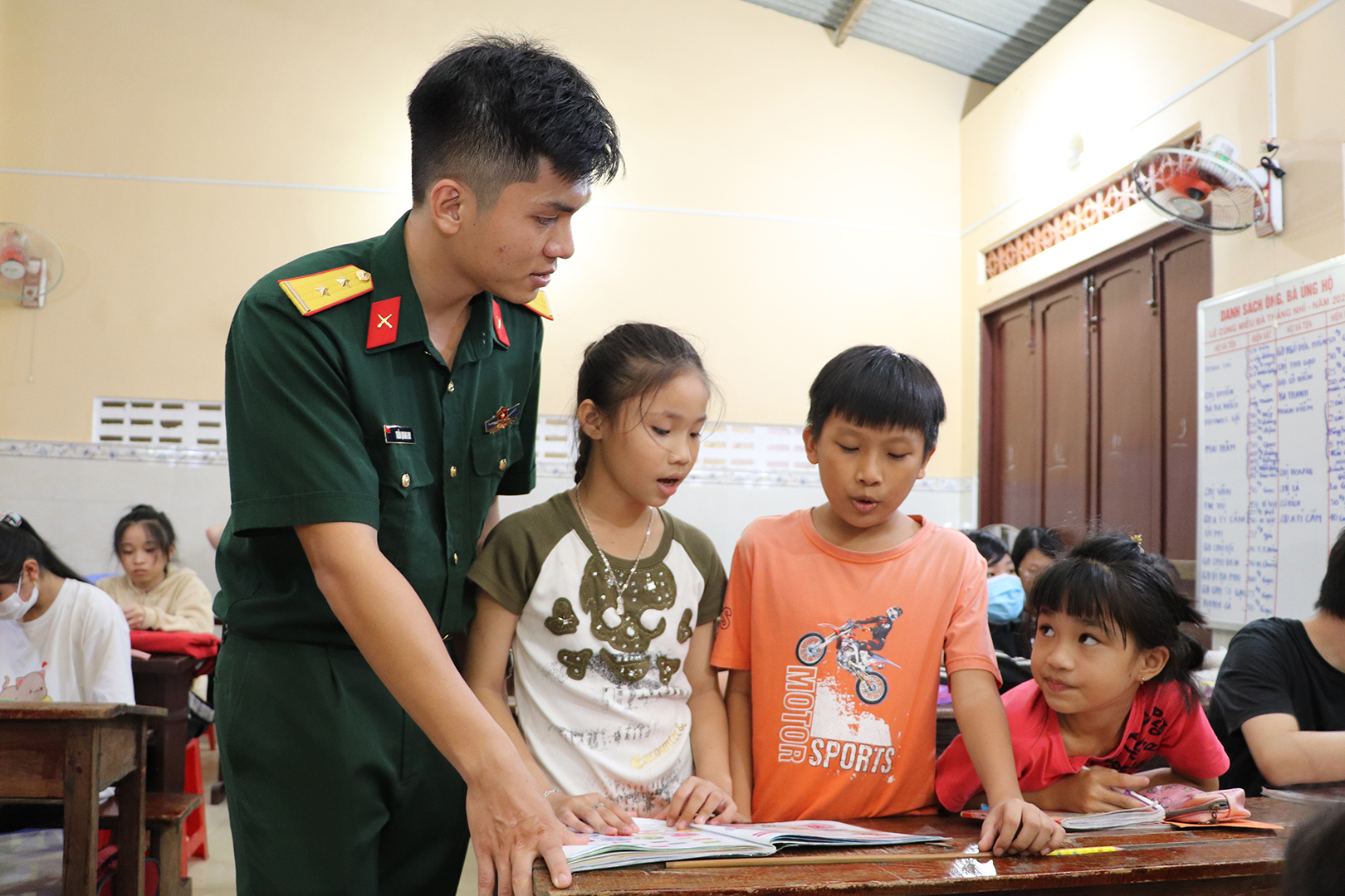 Trung úy Trần Quang Huy hướng dẫn các em phát âm.
