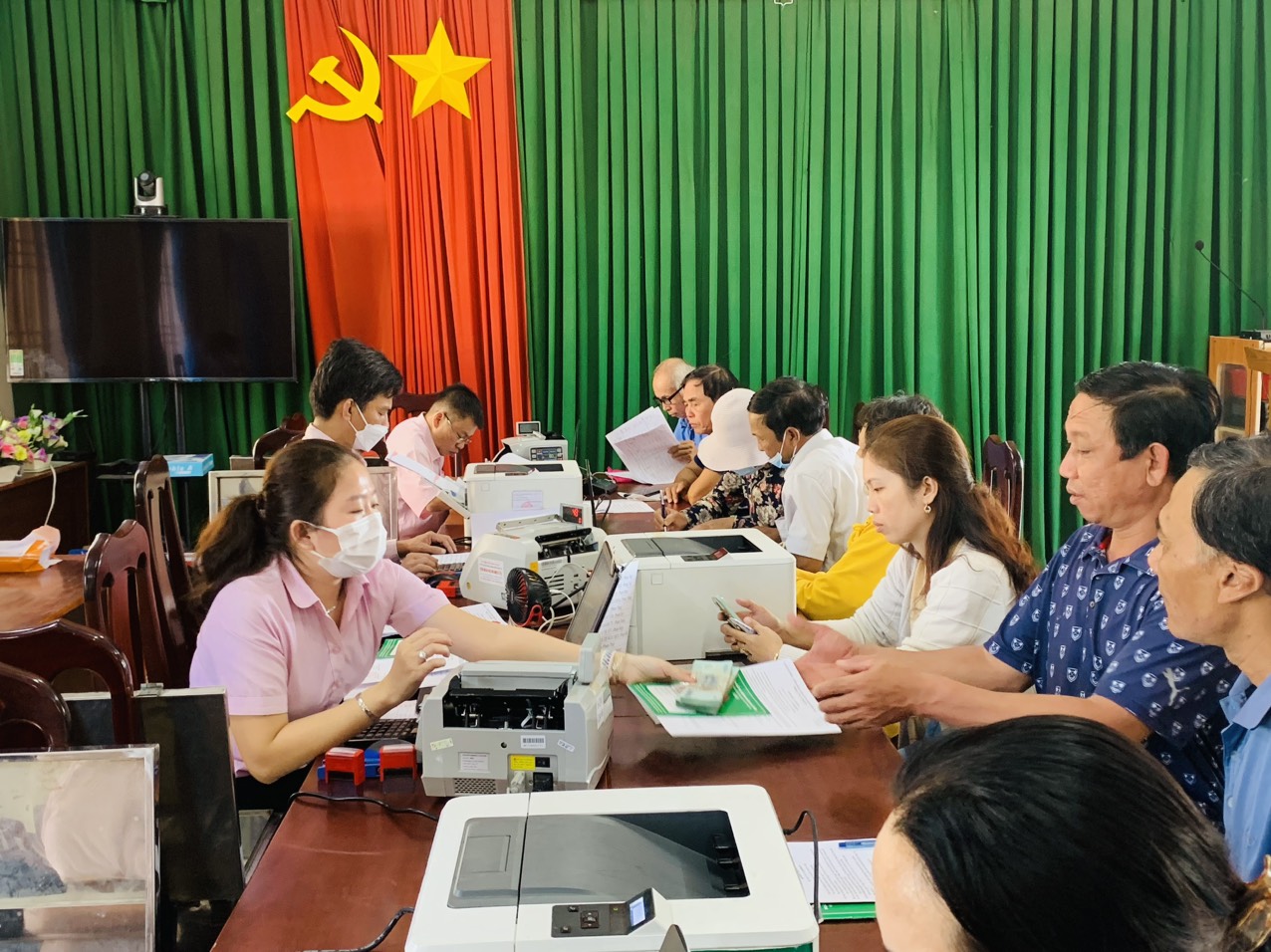 Nhân viên Phòng Giao dịch Ngân hàng Chính sách xã hội huyện Long Điền trao vốn vay giải quyết việc làm cho người dân xã Phước Tỉnh.