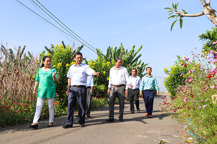 Ông Hoàng Quốc Thái (hàng đầu), Phó Bí thư Thường trực Đảng ủy xã Nghĩa Thành cùng cán bộ Hội Nông dân xã đi vận động người dân trồng, chăm sóc hoa trên các tuyến đường nông thôn.