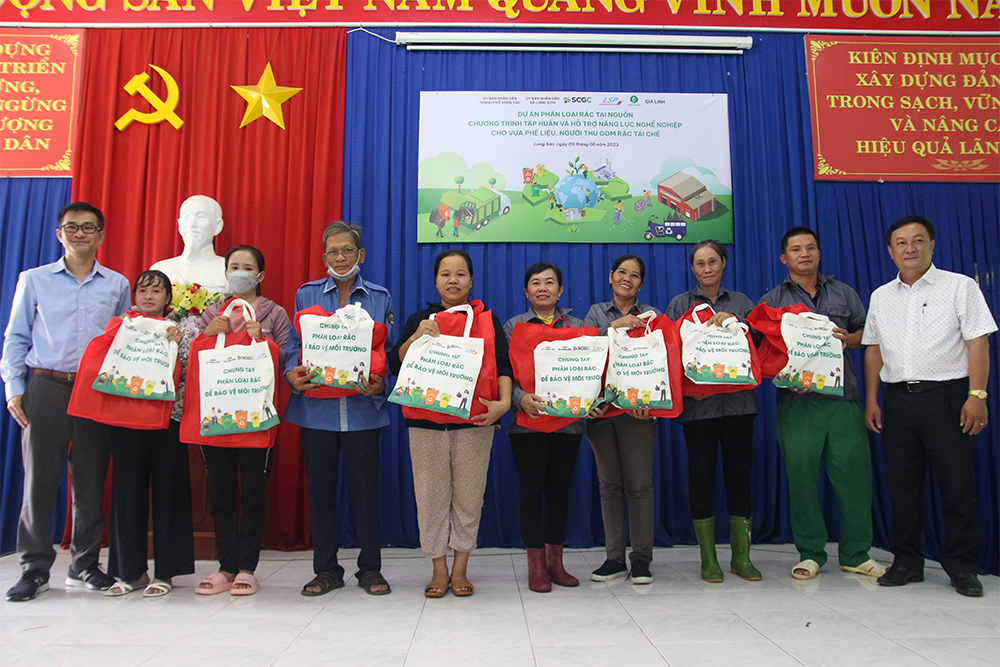 Đại diện UBND xã Long Sơn, Công ty TNHH Đại chúng Hoá dầu SCG (SCGC) và Công ty TNHH Hoá dầu Long Sơn (LSP) trao tặng bảo hộ lao động và quà cho người thu gom rác và vựa phế liệu.