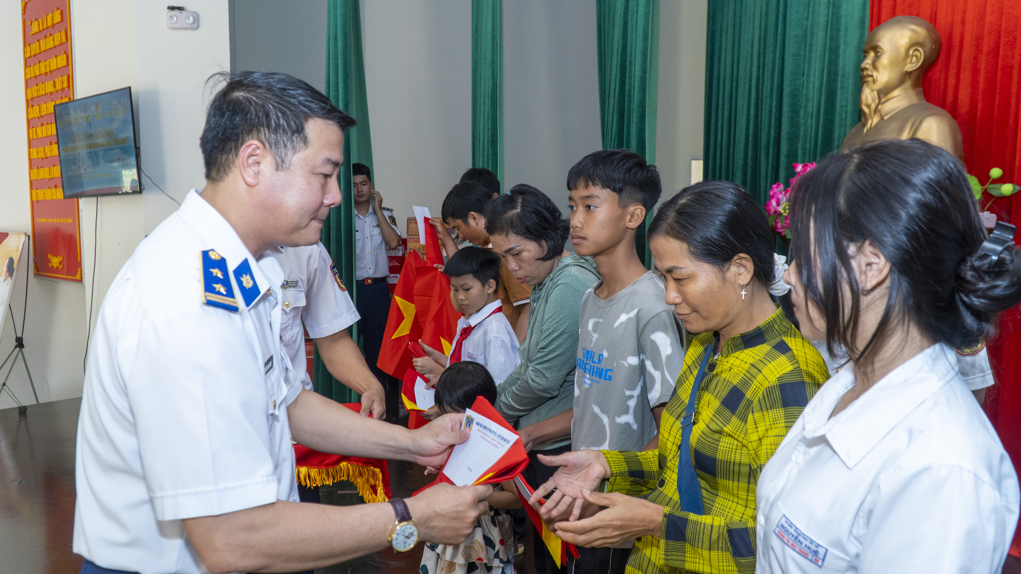 Trung tá Nguyễn Văn Thủy, Bí thư Đảng ủy, Chính trị viên Đoàn Đặc nhiệm PCTP ma túy số 3 trao cờ Tổ quốc và quà cho người dân xã Phước Hưng.