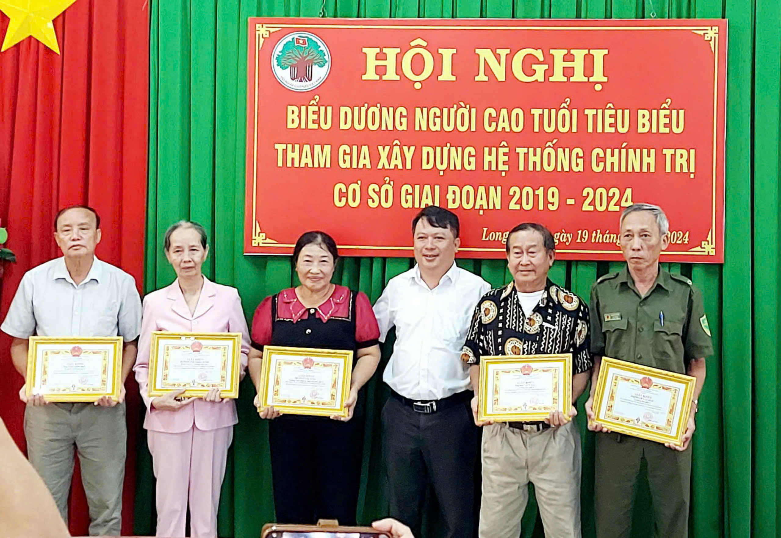 Ông Đỗ Văn Lăng (thứ hai từ phải qua) nhận Giấy khen vì đã có thành tích xuất sắc trong phong trào  Người cao tuổi tiêu biểu tham gia xây dựng hệ thống chính trị ở cơ sở giai đoạn 2019-2024.