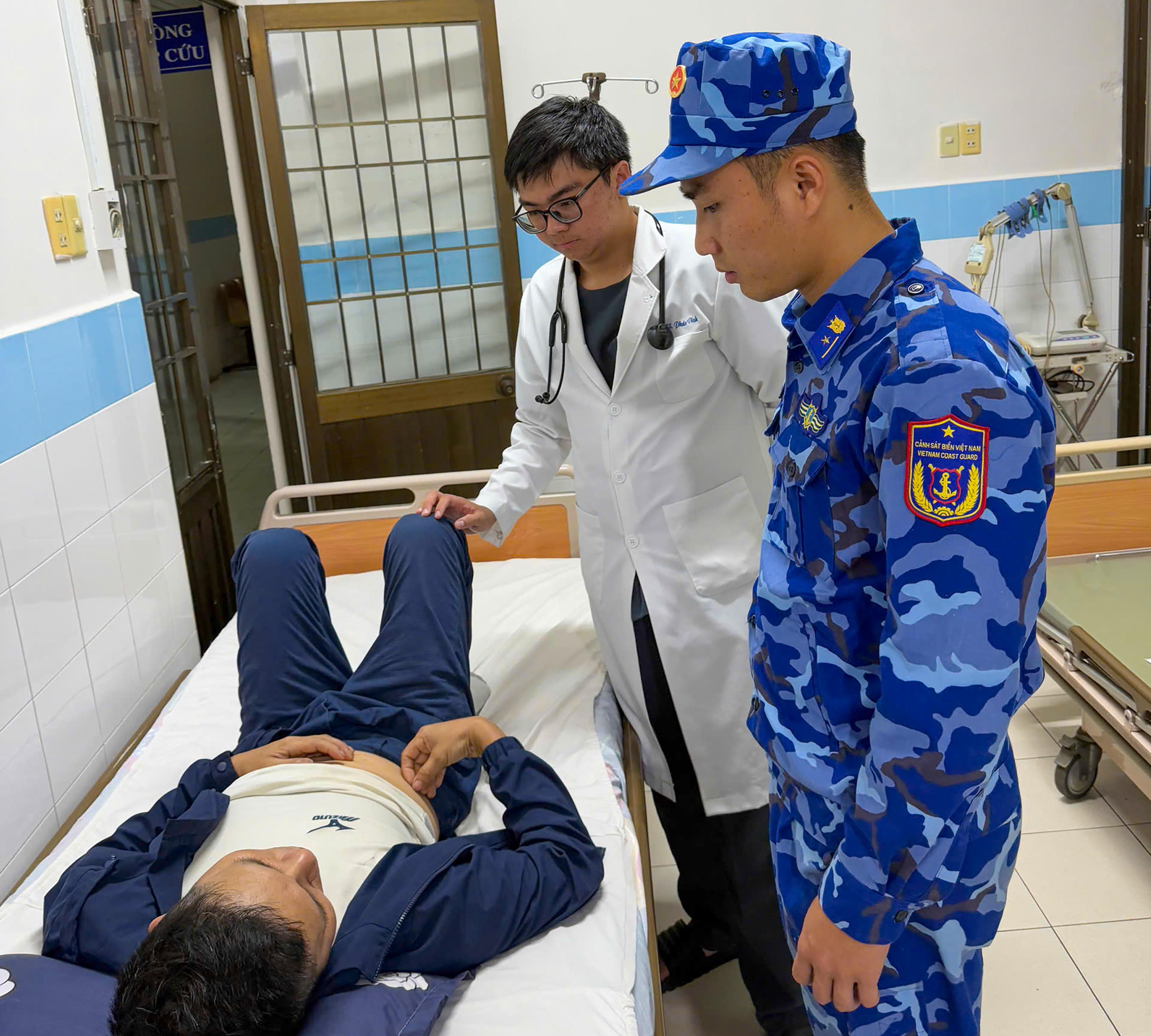 Nhân viên y tế của Trung tâm y tế quân dân y huyện Côn Đảo cấp cứu, thăm khám sức khỏe cho thuyền viên Đào Văn Quang.