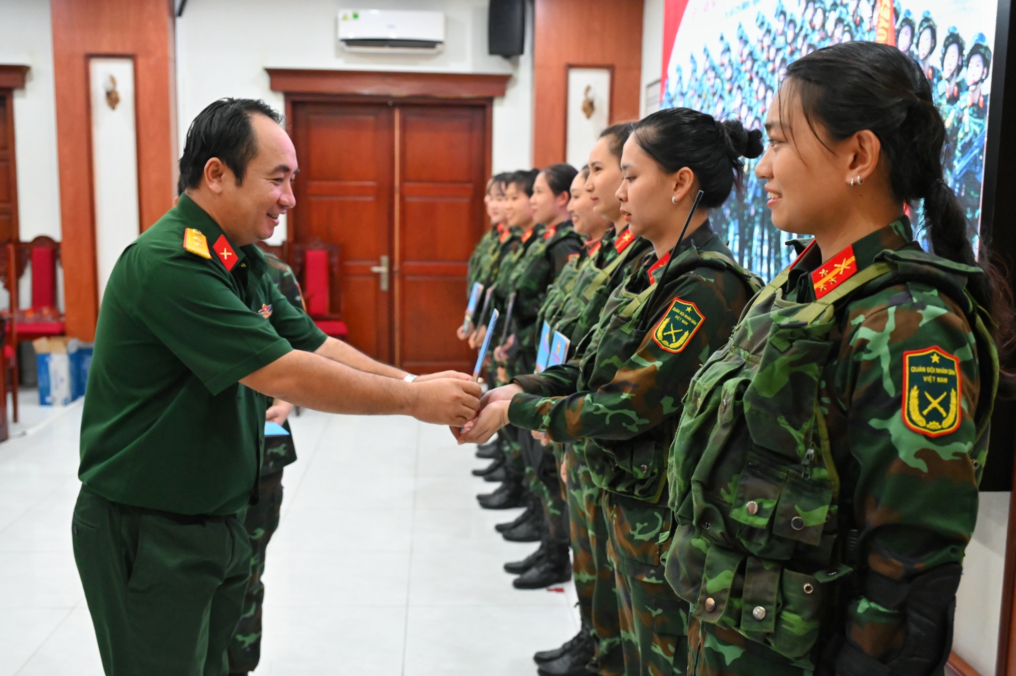 Trung tá Ngô Khánh, Chính ủy Bộ Chỉ huy Quân sự tỉnh tặng quà nữ cán bộ, chiến sĩ thuộc Bộ Chỉ huy Quân sự tỉnh tham gia luyện tập diễu binh khối nữ đặc công Sài Gòn.