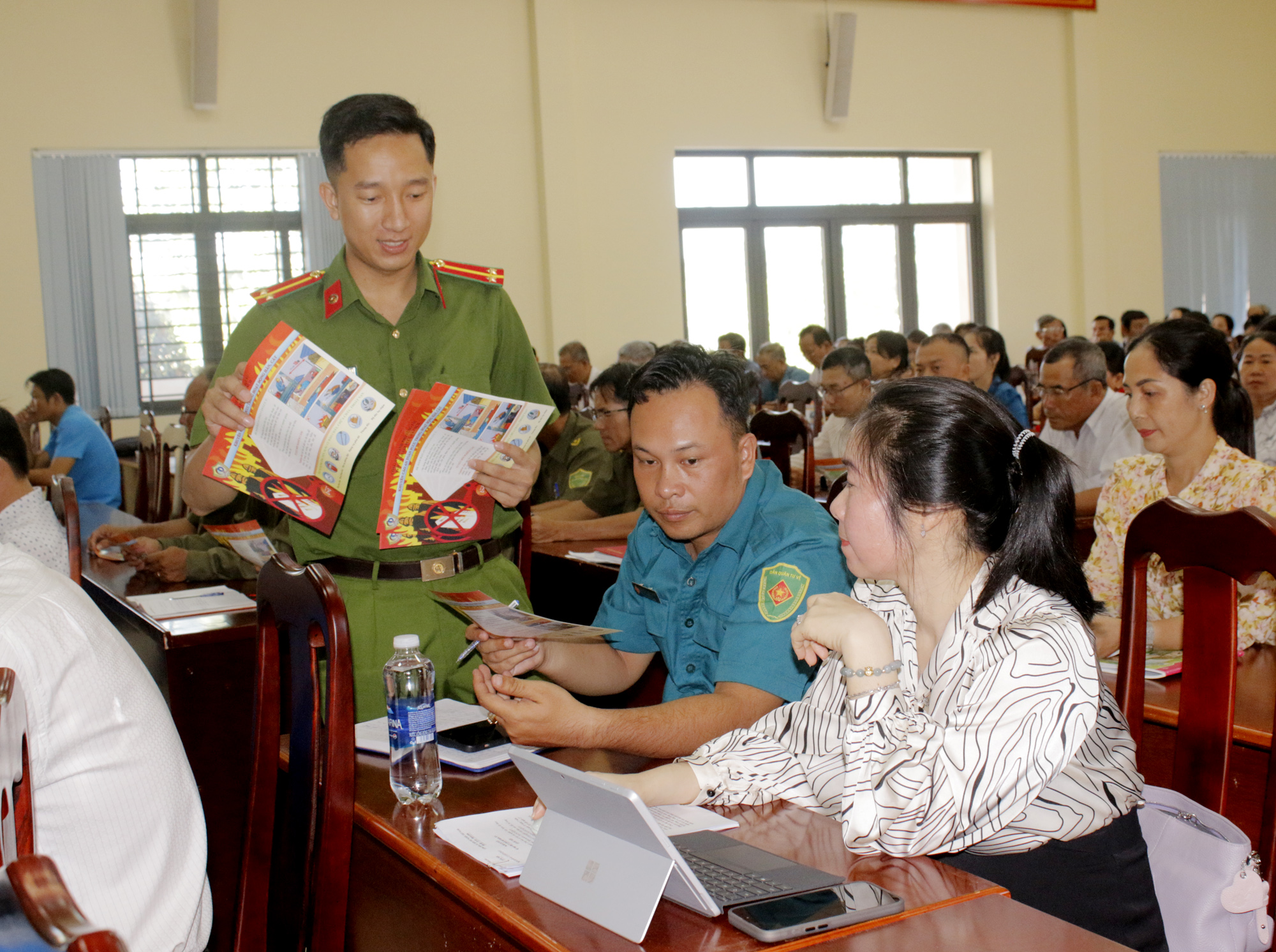 Cán bộ Đội chữa cháy và cứu nạn, cứu hộ khu vực 28-Phòng PC07, Công an TPHCM phát tờ rơi tuyên truyền về khuyến cáo an toàn PCCC tại hội nghị.